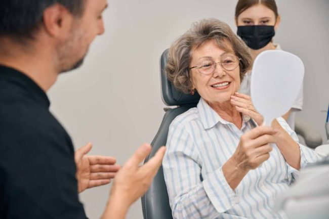 Pensioner,At,A,Dentists,Appointment,Looks,At,Her,Teeth,In restorative dentist taylorsville